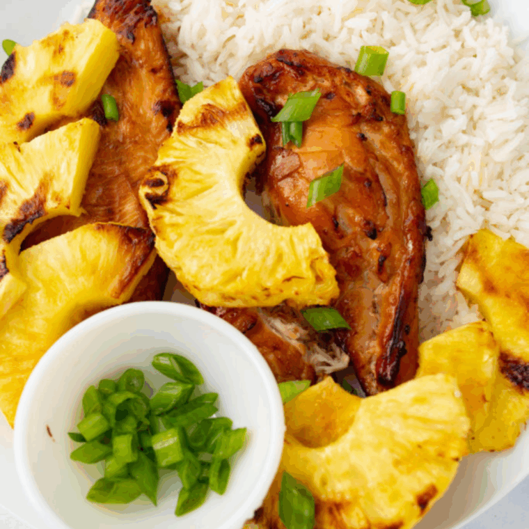 Marinated chicken in pineapple, soy, garlic, and brown sugar mixture ready for air fryer grilling.