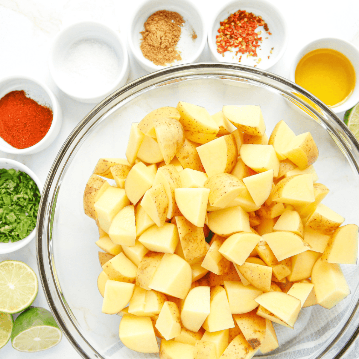 Ingredients needed for Easy Air Fryer Chili Lime Potatoes on kitchen table.