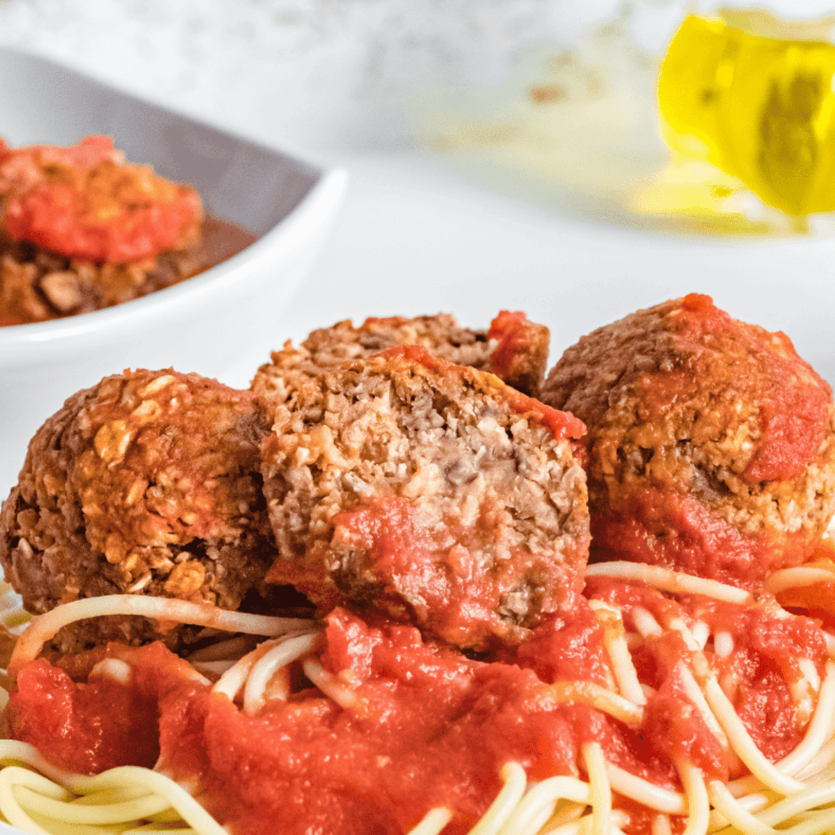 Air fryer vegan meatballs cooked to golden perfection, served on a plate with marinara sauce
