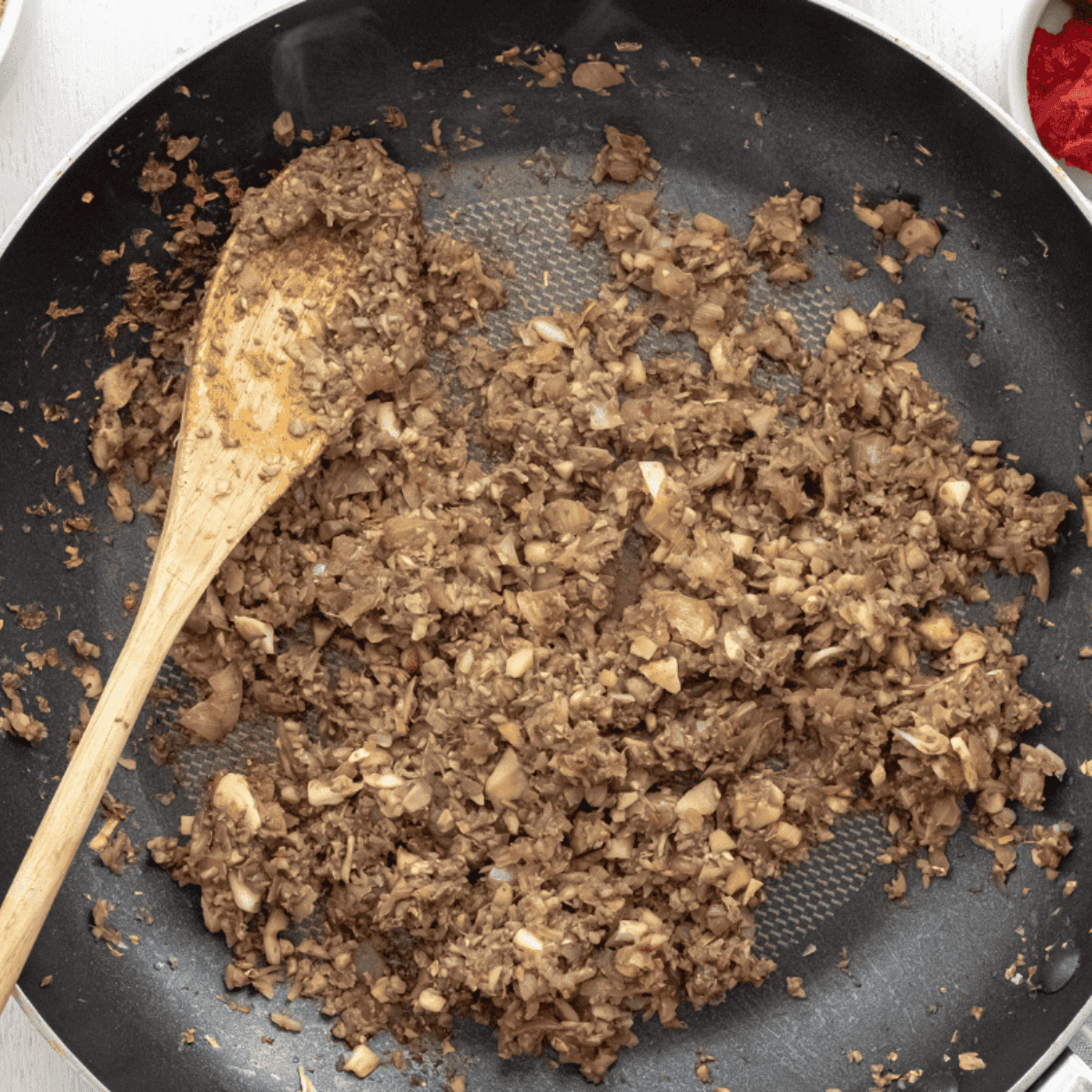 Finely diced onions cooking in a large skillet over medium heat until translucent.