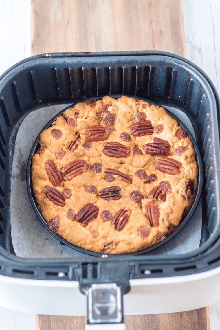 Melting caramel bits with heavy cream in a microwave-safe bowl to create a smooth sauce.