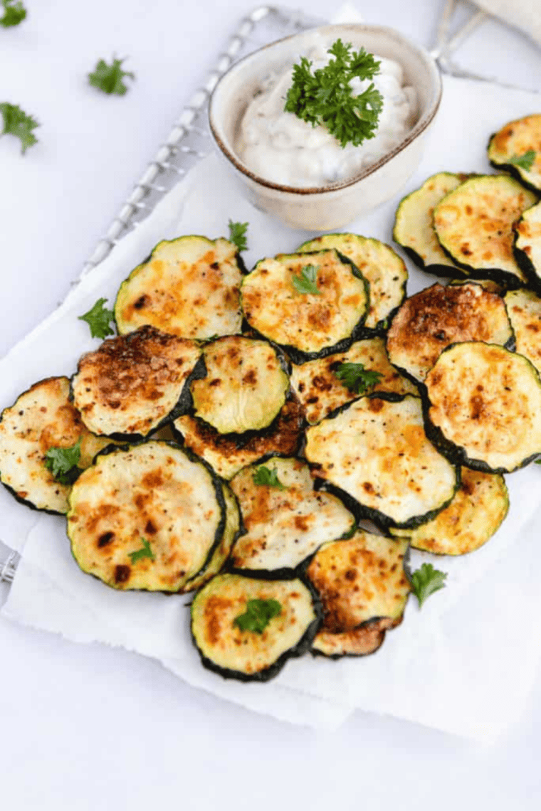 Crispy, golden dehydrated zucchini slices made in an air fryer, ready to eat.