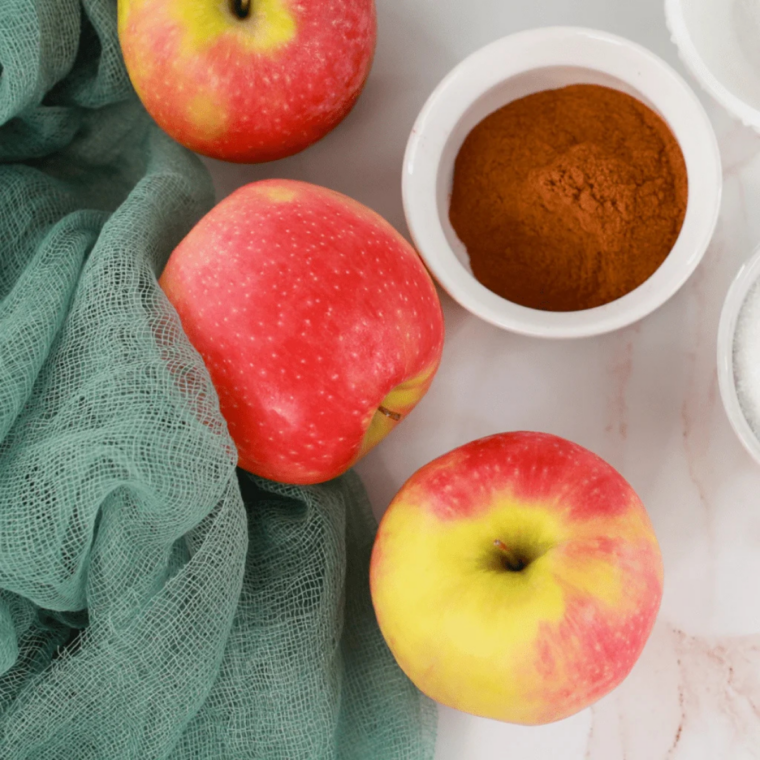 Ingredients needed for How to Dehydrate Apples in an Air Fryer (Crispy Cinnamon Apple Chips) on kitchen table.