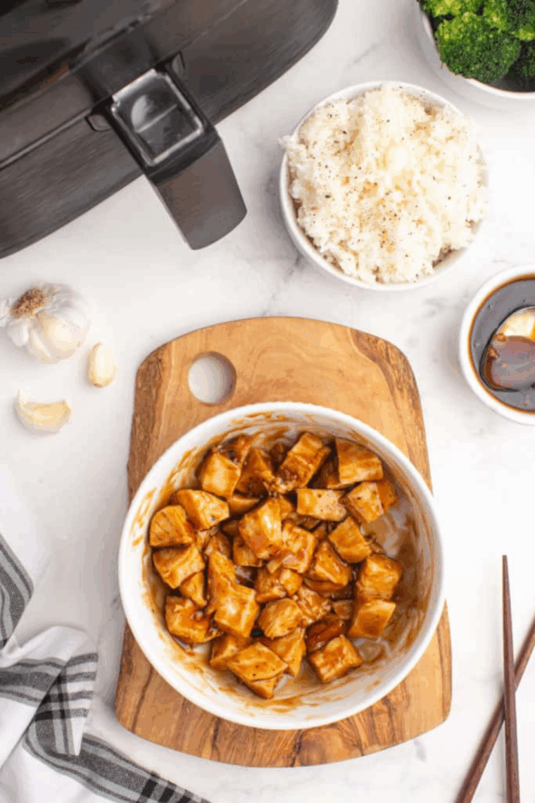 Chicken mixed with Teriyaki Sauce in Bowl.