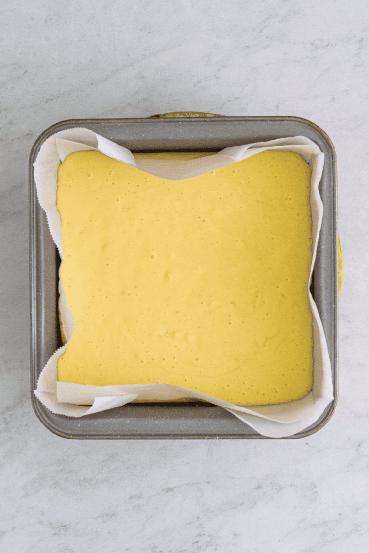 Creamy cheesecake filling with white chocolate chips in a food processor.