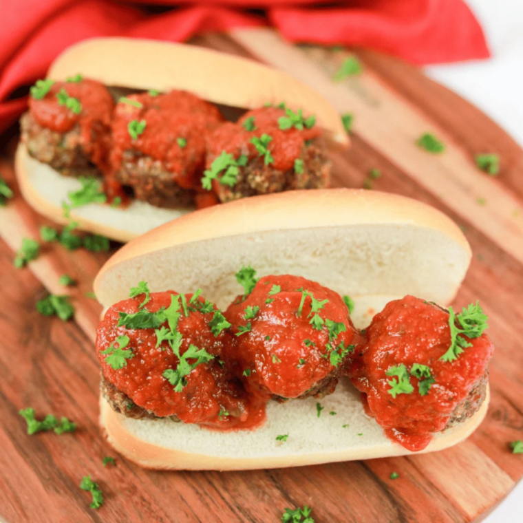 Juicy chicken meatballs cut open to show the tender center, served with dipping sauce
