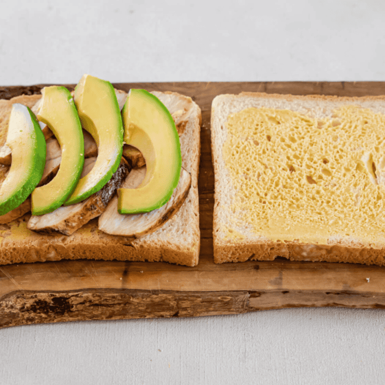 Adding the toppings onto the sandwich.