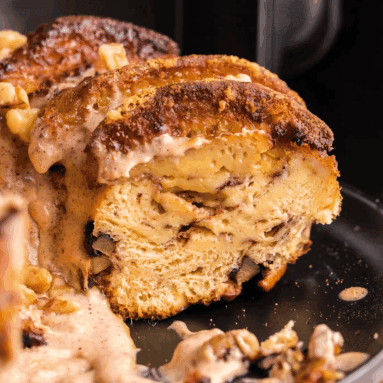Pouring creamy eggnog glaze over baked cinnamon monkey bread before serving