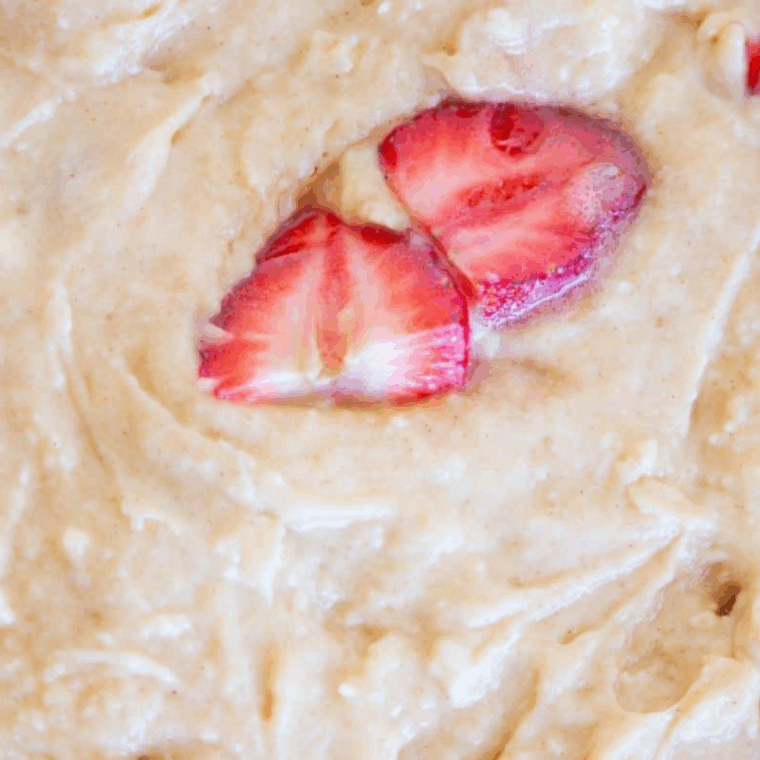 Air Fryer Strawberry Cobbler with dough scooped over strawberries, baked until golden, served with vanilla ice cream.