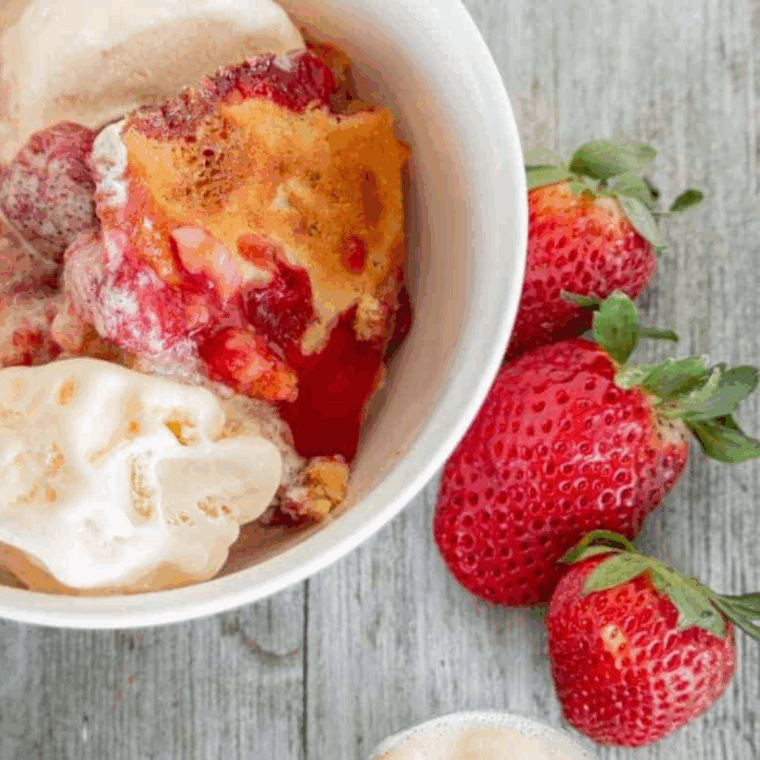 Air Fryer Strawberry Cobbler with juicy strawberries and golden, crumbly topping served in a bowl.