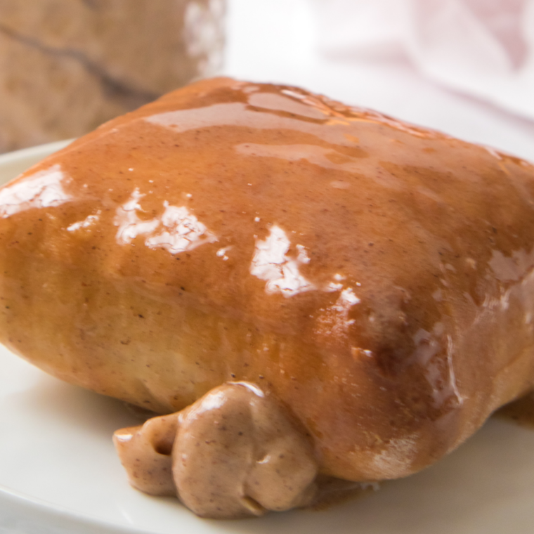 Brushing honey cinnamon glaze on hot air fried Texas Roadhouse rolls