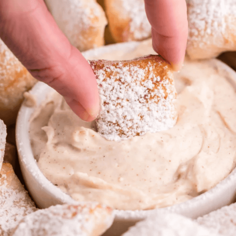 Bowl of sweet glaze dip served with warm cinnamon sugar pretzel bites