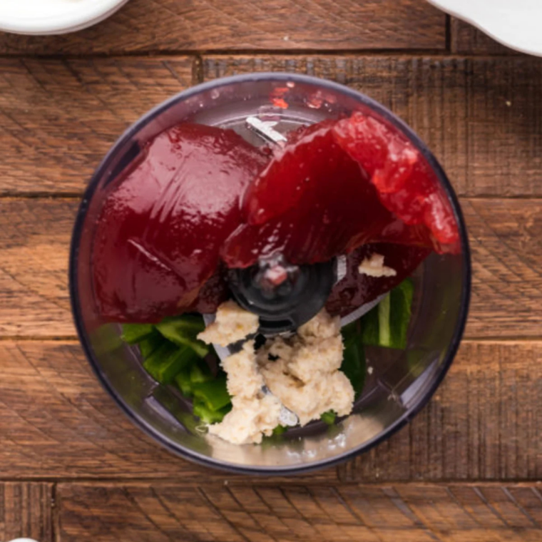 Cranberry sauce, sour cream, horseradish, and chopped jalapeno in a food processor bowl
