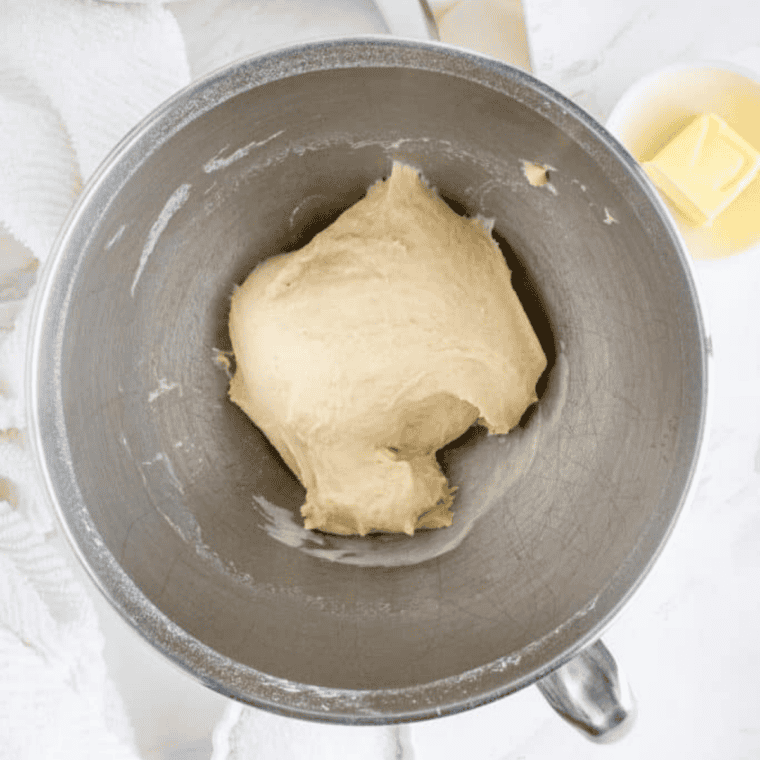 Smooth pretzel dough kneaded in a bowl, ready to rise