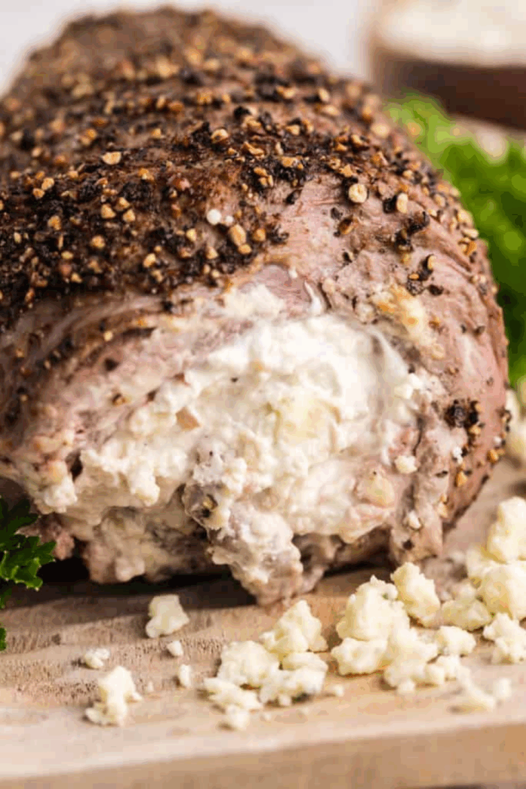 Sliced Black and Blue steak showing a dark, nearly black crust and a cool, bright red interior (blue-rare), served on a white plate.