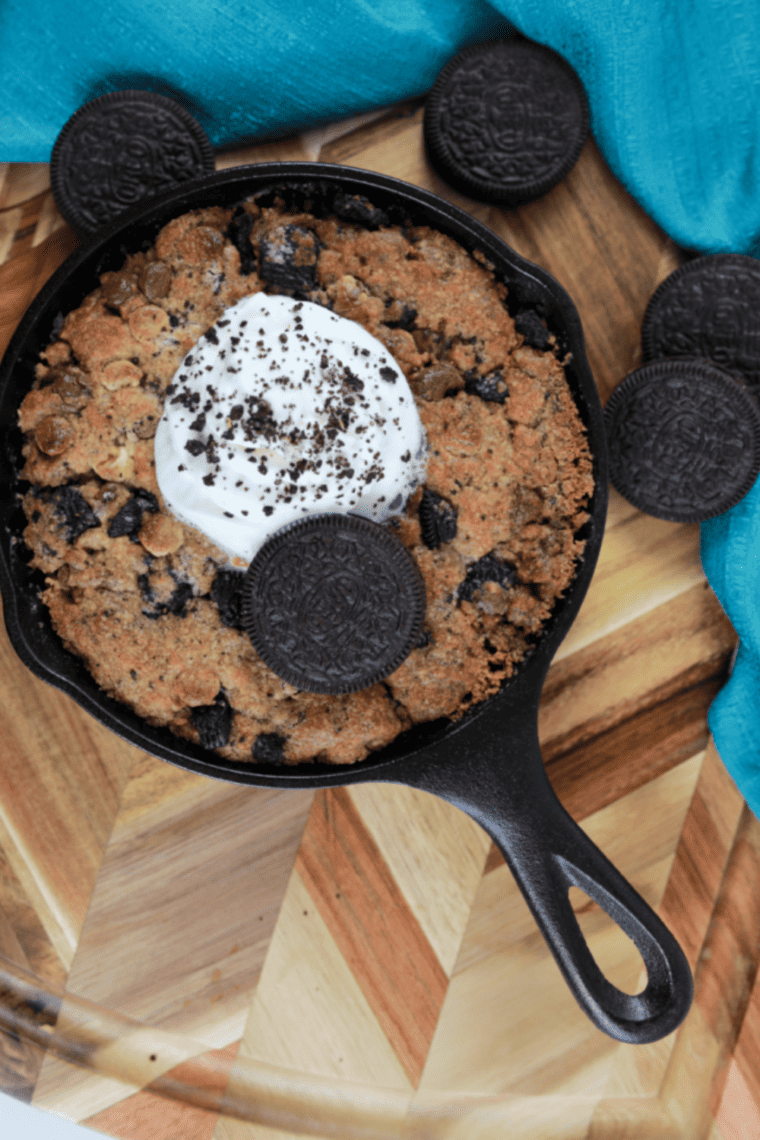 Plate of Air Fryer Cookies & Cream Pizzokie with melted chocolate and crushed Oreos