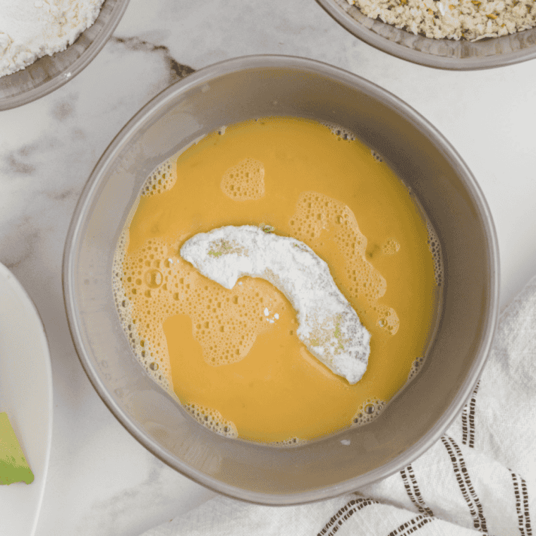 avocado wedges dipped in egg and coated with seasoned breadcrumbs for air frying