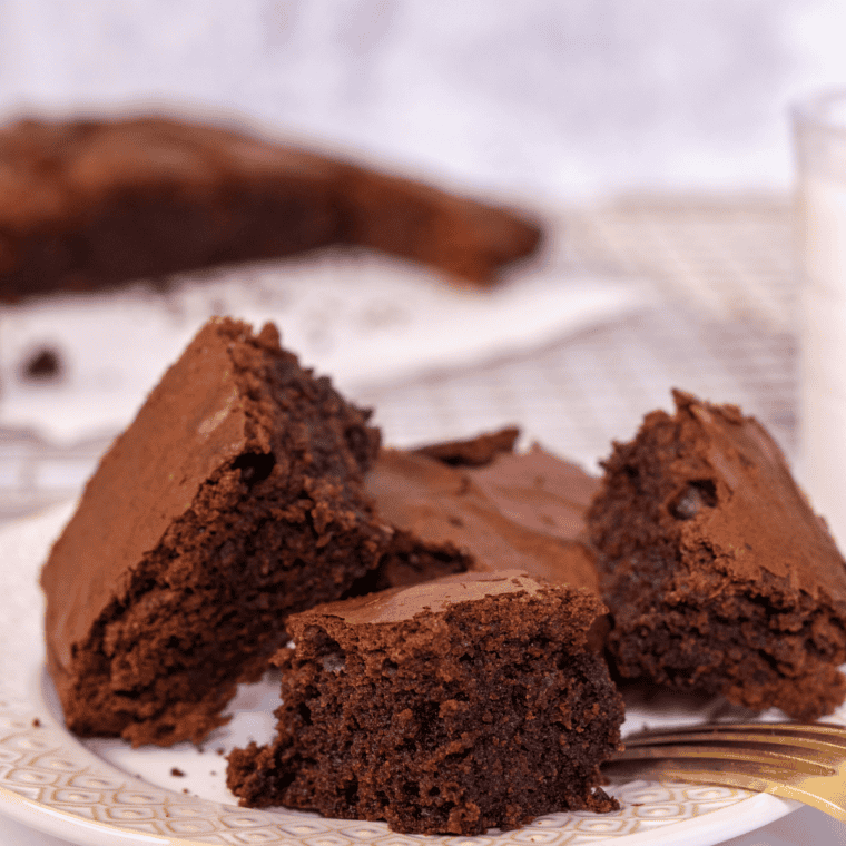 Sliced vegan brownies on a cutting board showing a dense, fudgy texture