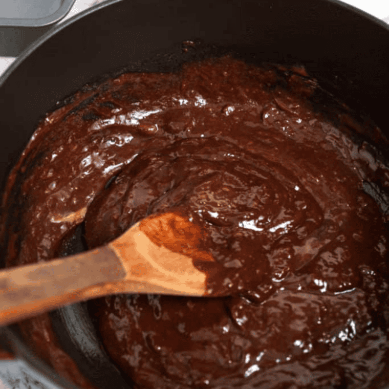 Ground flaxseed stirred into water in a small bowl, thickened into a gel-like flax egg