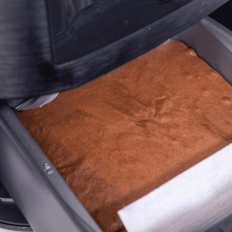 Baked air fryer vegan brownies cooling in the pan before slicing