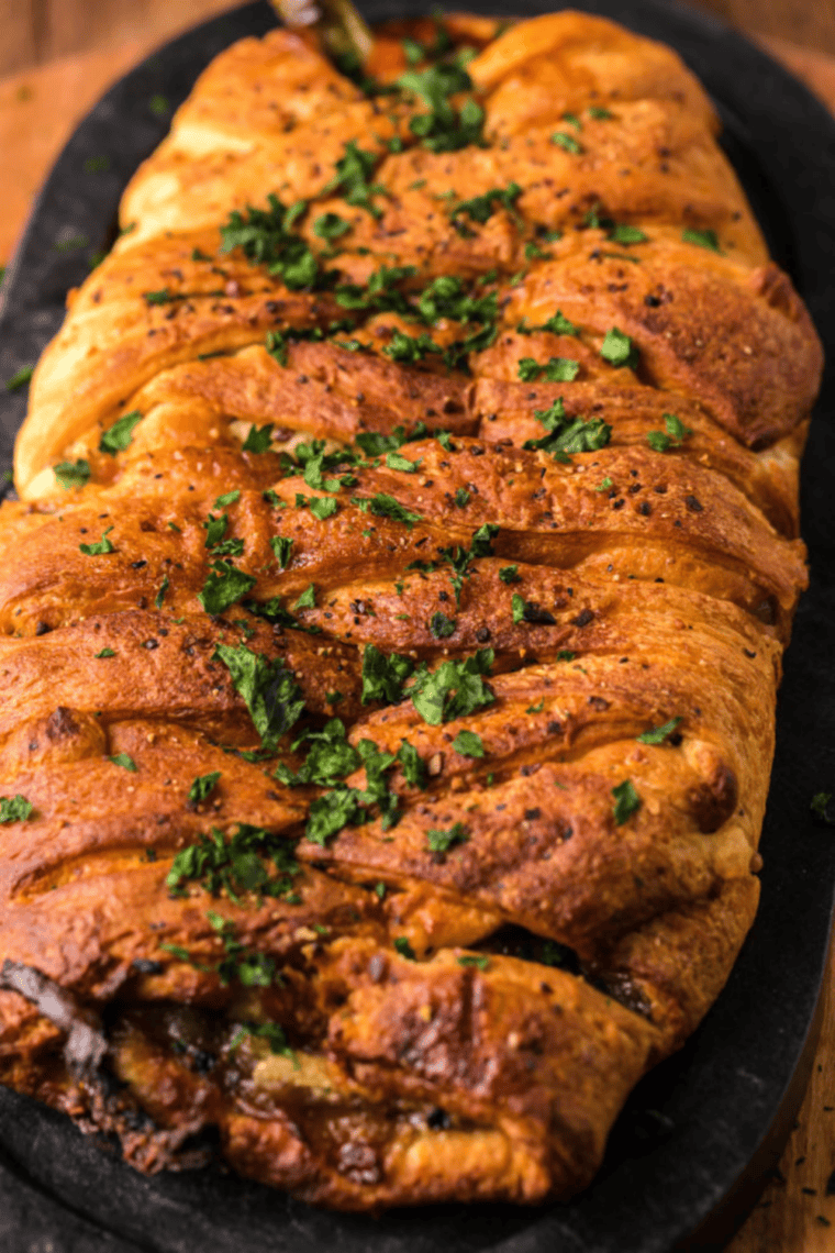 Crispy Air Fryer Vegan Philly Wrap sliced in half, filled with plant-based steak, saut&eacute;ed peppers, and onions, ready to serve.