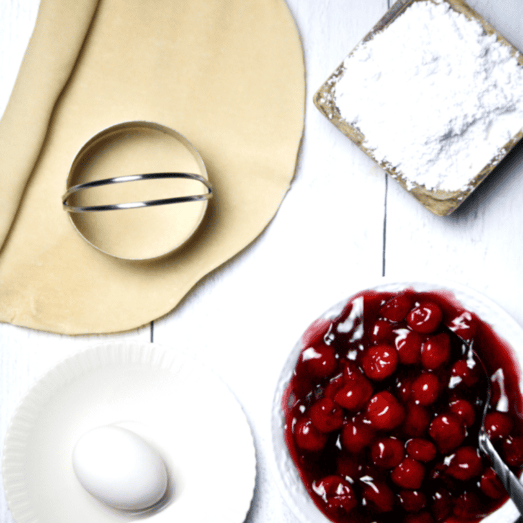 Ingredients needed for Easy Air Fryer Cherry Pie Bombs on kitchen table.