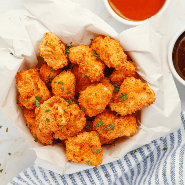 Golden, crispy air fryer popcorn chicken bites on a plate, seasoned like KFC, ready to serve.