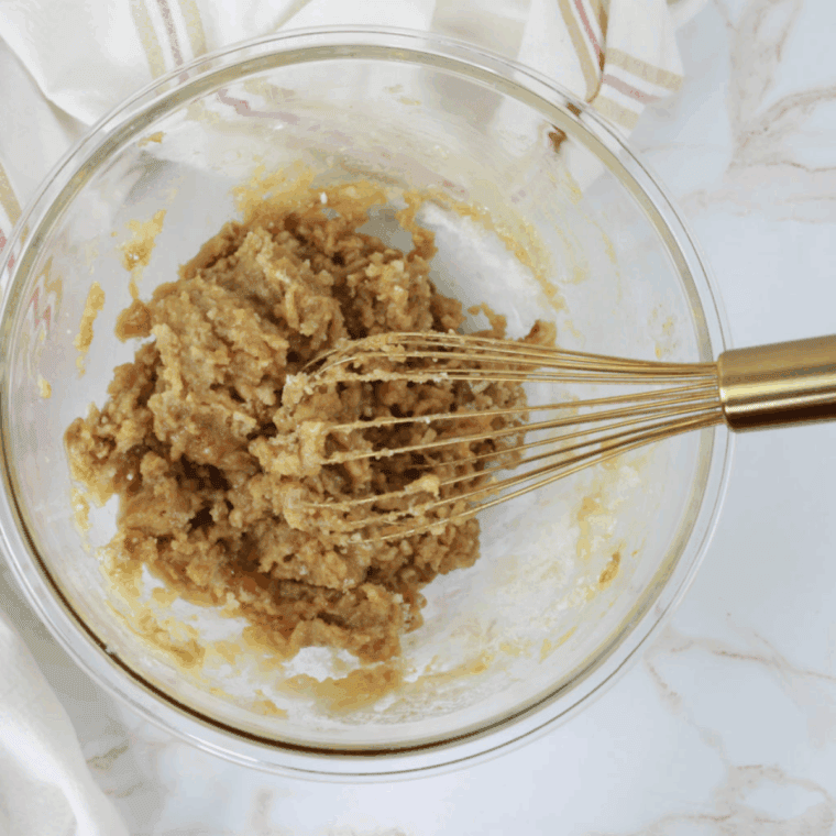 Mixing flour, baking soda, salt, butter, sugars, egg, and vanilla in a large bowl