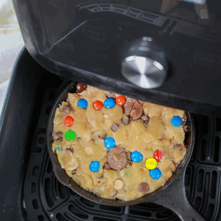 Air fryer set to 320°F with cookie dough in pan, ready to cook