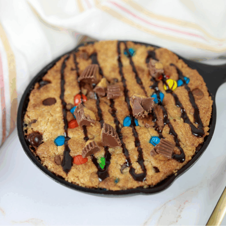 Golden-brown Air Fryer Peanut Butter Pizzokie with a soft, gooey center and chocolate and peanut butter candy mix