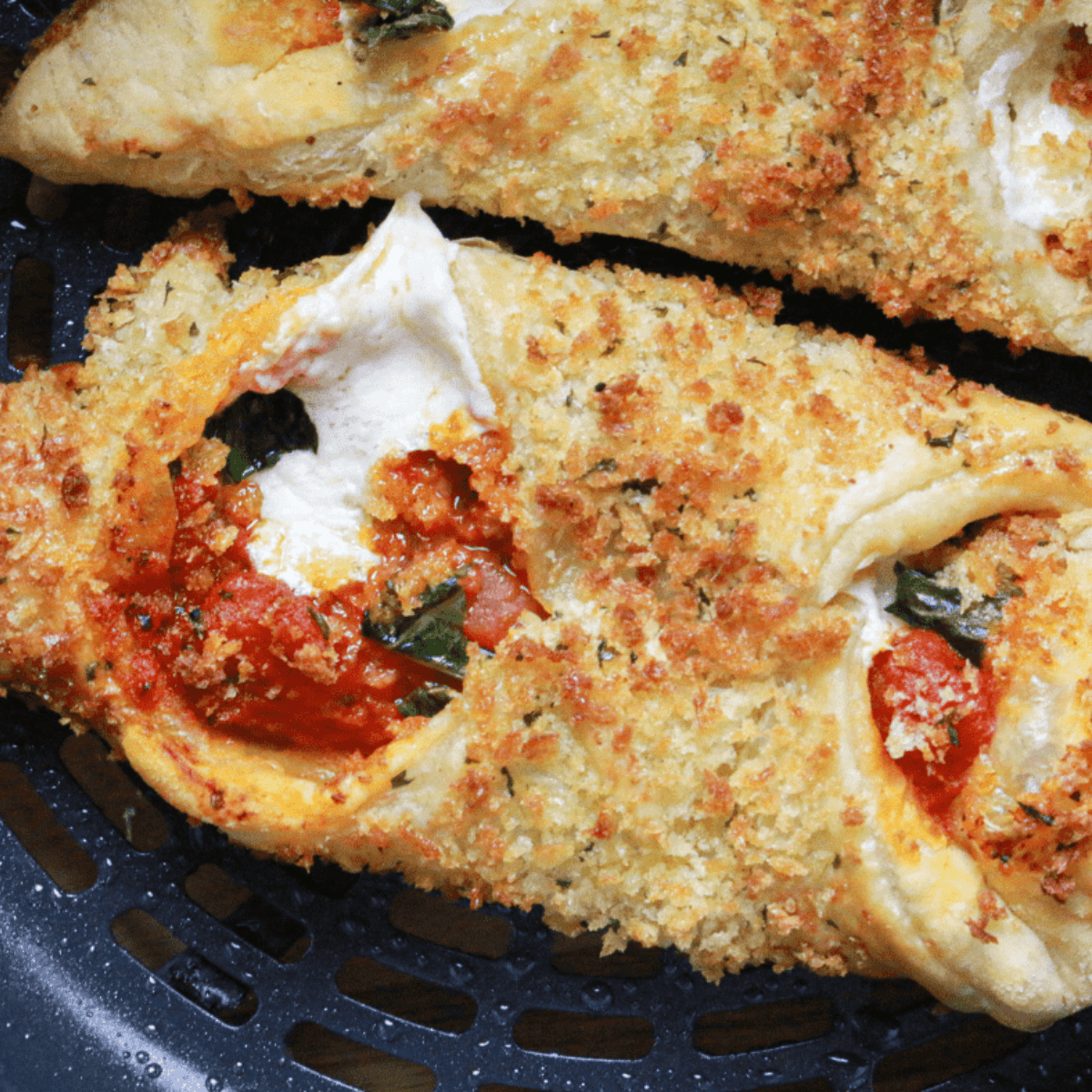 Air Fryer Pizza Cannoli with crispy shells filled with melted cheese and pizza toppings on a serving plate.