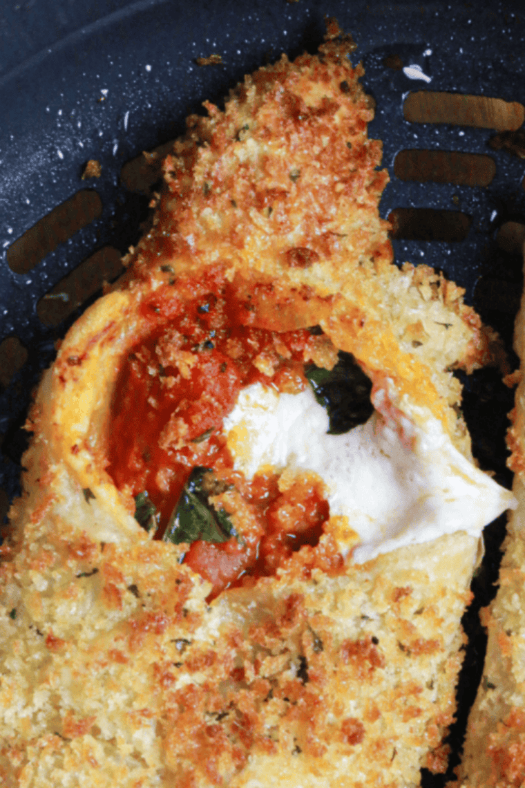 Crispy Air Fryer Pizza Cannoli filled with melted cheese and pizza toppings served on a plate