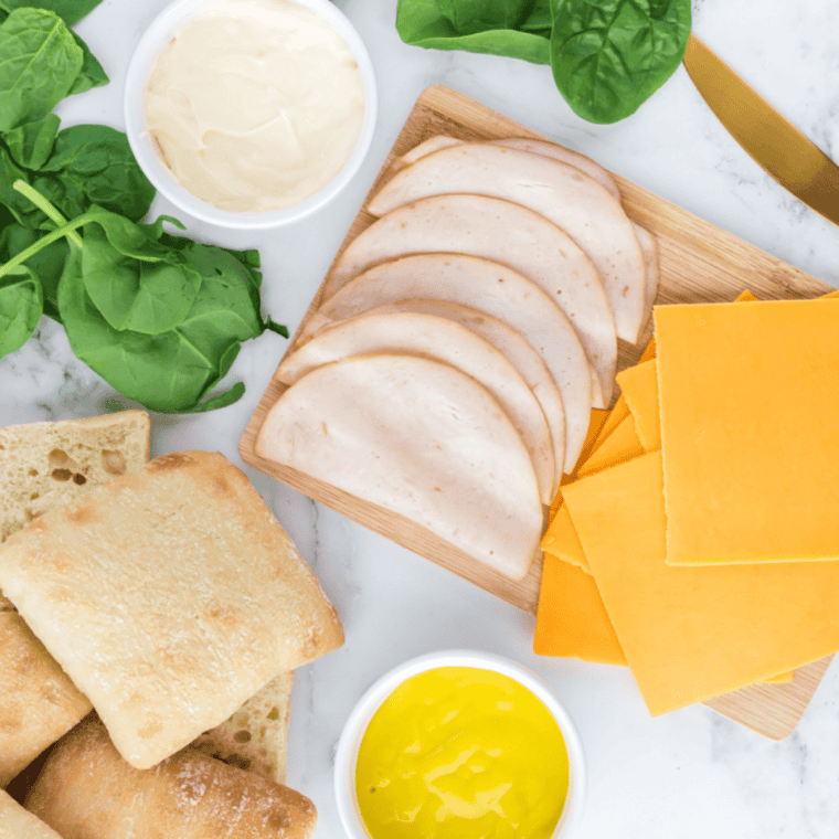Ingredients needed for Easy Air Fryer Turkey And Cheese Sandwich Recipe on kitchen table.