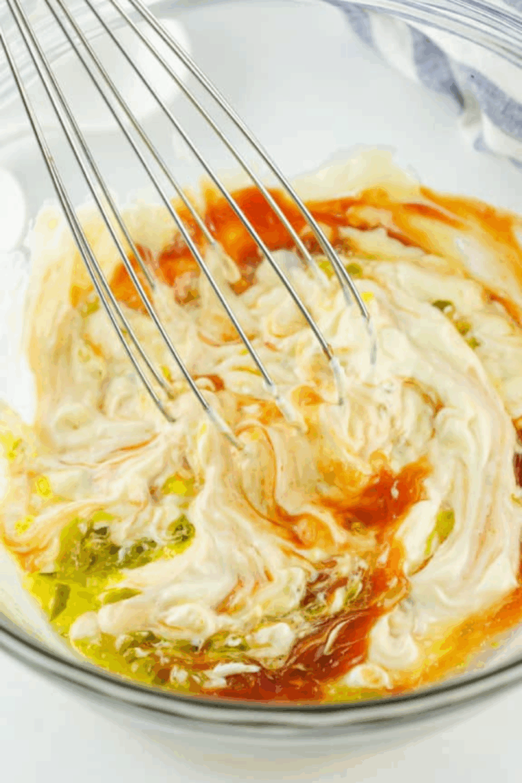 Whisking together all ingredients in a large bowl to make smooth Freddy&rsquo;s fry sauce