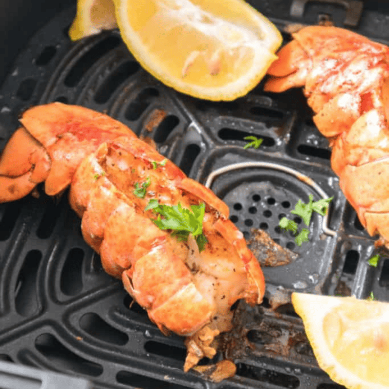 Frozen lobster tails cooked in air fryer with melted butter and lemon.