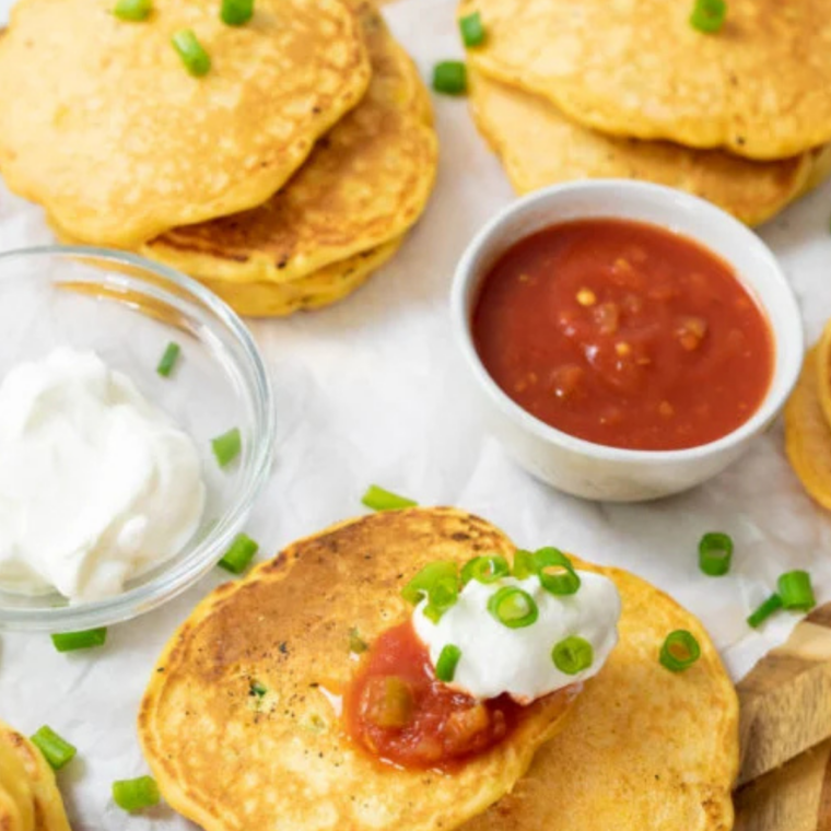 Honey butter dripping down a warm stack of corn cakes.