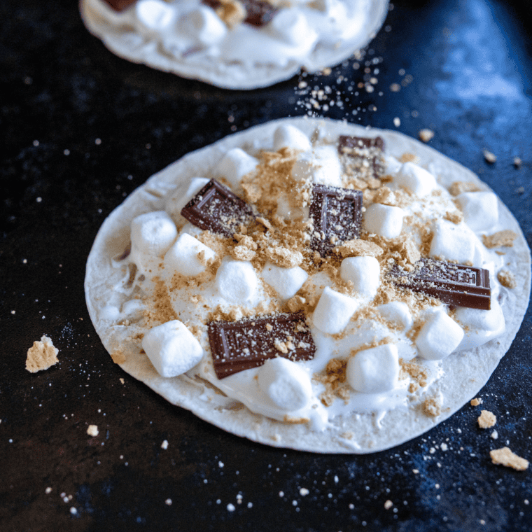 Griddle covered with a metal lid to melt chocolate and marshmallows until golden and gooey