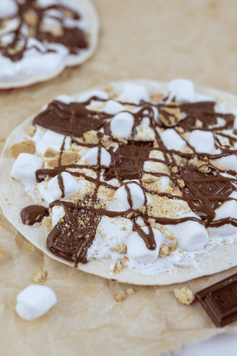 Blackstone Grill s&rsquo;mores pizza with melted chocolate, toasted marshmallows, and graham crackers on a golden crust