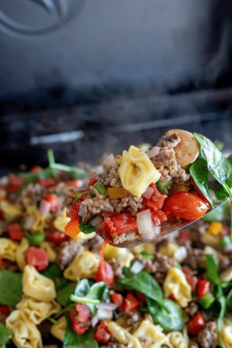 Close-up of cheesy tortellini griddle recipe on Blackstone outdoor cooker