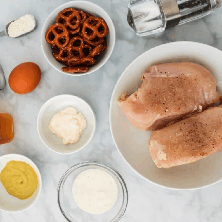 Ingredients needed for Easy Pretzel Crusted Air Fryer Chicken Tenders on kitchen table.