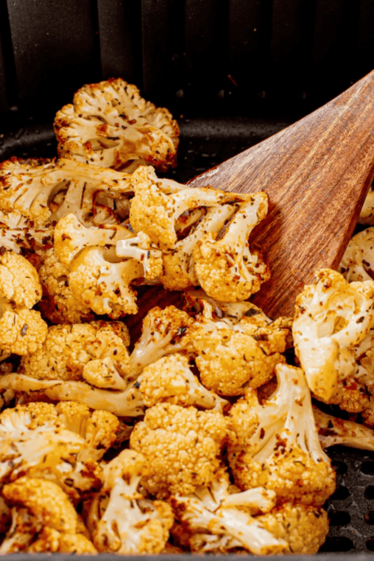 Crispy golden air fryer frozen cauliflower served in a bowl, ready to eat.