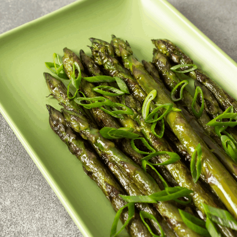 Fresh asparagus spears grilled to perfection in the Ninja Foodi Grill, lightly seasoned and slightly charred.