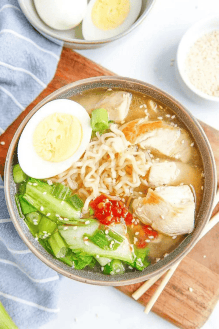 overhead view of a bowl of slow cooker chicken ramen with egg, chicken and nori