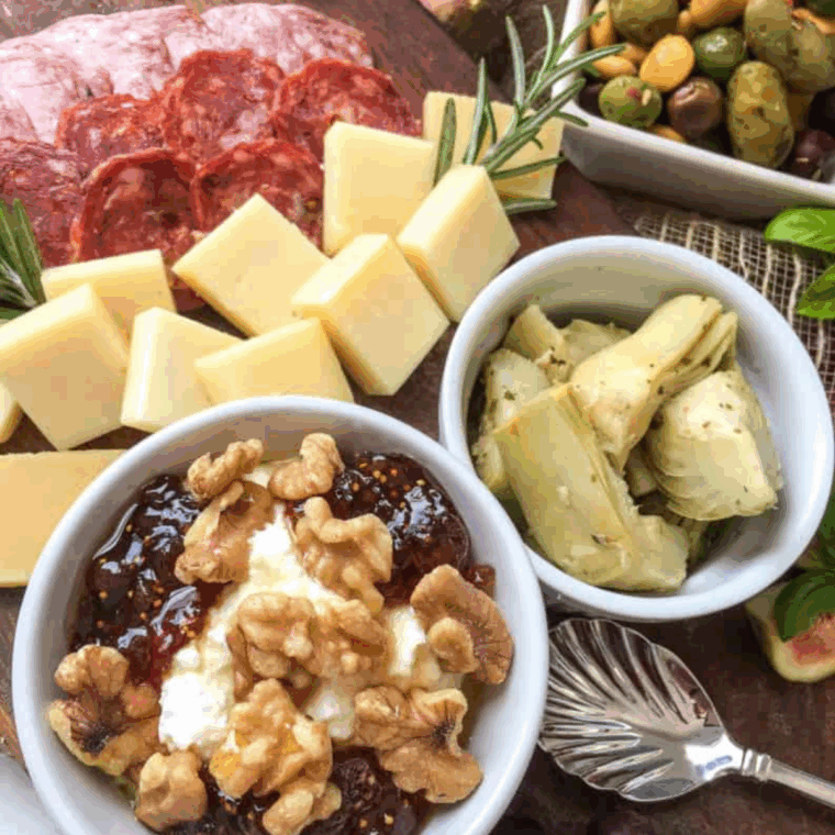 Air fryer Italian charcuterie board featuring crispy bites, Italian meats, cheeses, and fresh garnishes arranged on a platter.