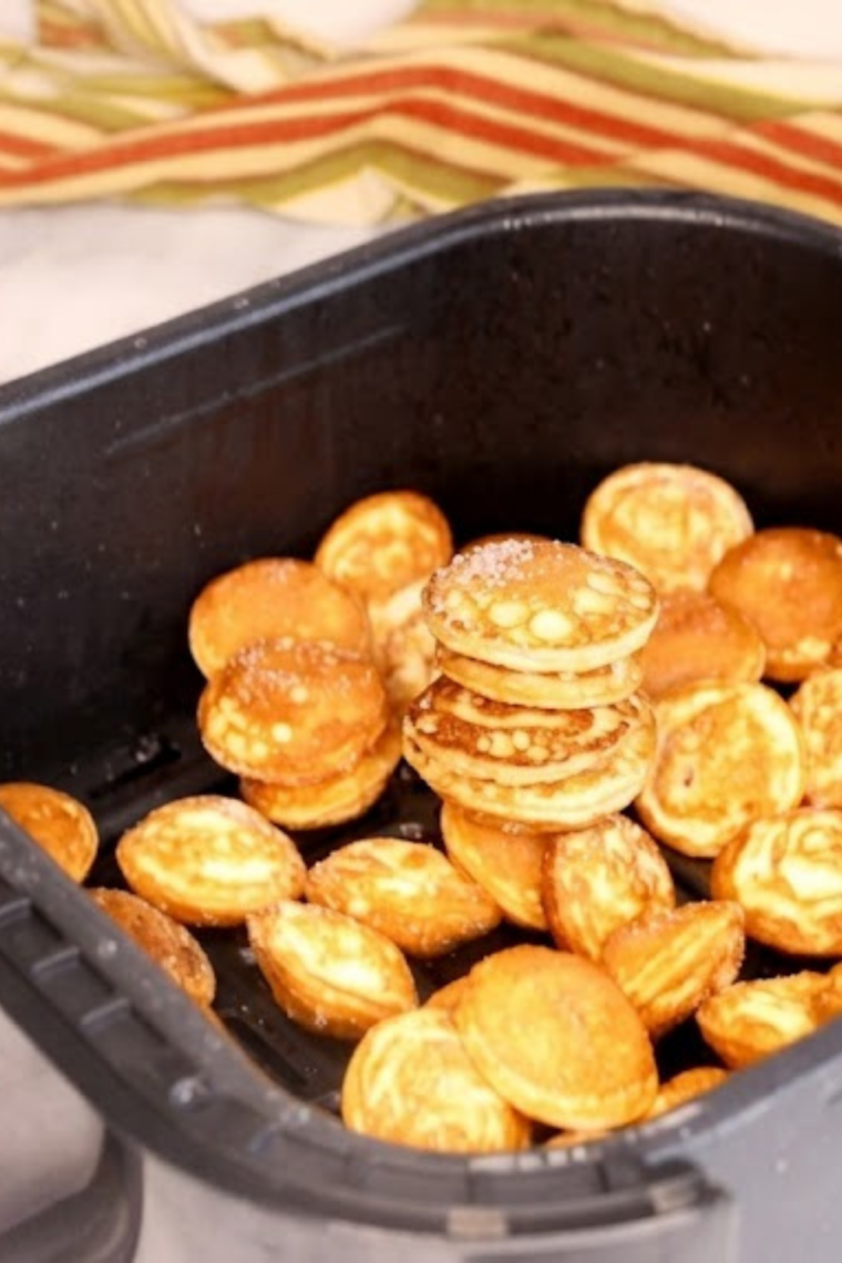 Frozen Trader Joe&rsquo;s pancake puffs placed into an air fryer basket without thawing or oil spray