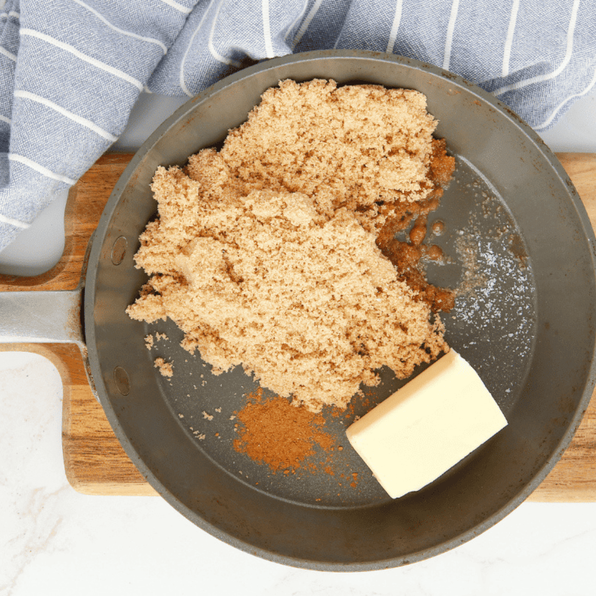 Melting butter, brown sugar, vanilla, cinnamon, and salt in a saucepan until thickened