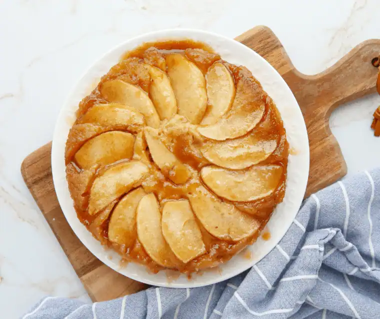 Upside down caramel apple cake with glossy caramel apple slices on top