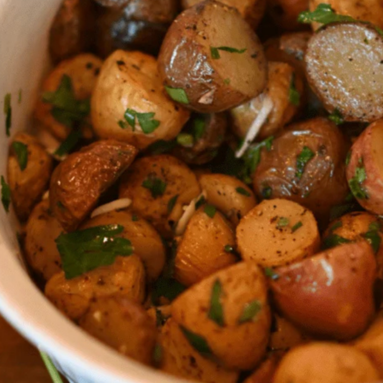 Crispy Blackstone griddle potatoes topped with fresh herbs just before serving, resting slightly after cooking for best flavor and texture