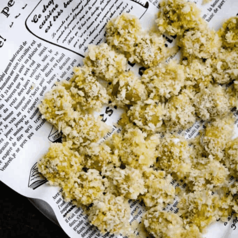 Breaded olives arranged in the air fryer basket, ready to cook at 400°F for 8–10 minutes.