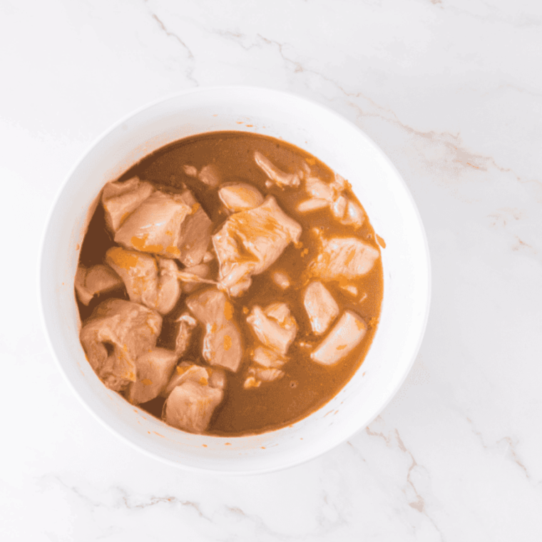 Mixing orange juice, vinegar, soy sauce, and orange zest in bowl for marinade